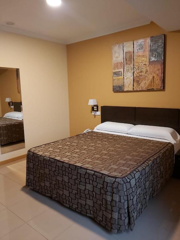 Postel nebo postele na pokoji v ubytování Hotel Reigosa