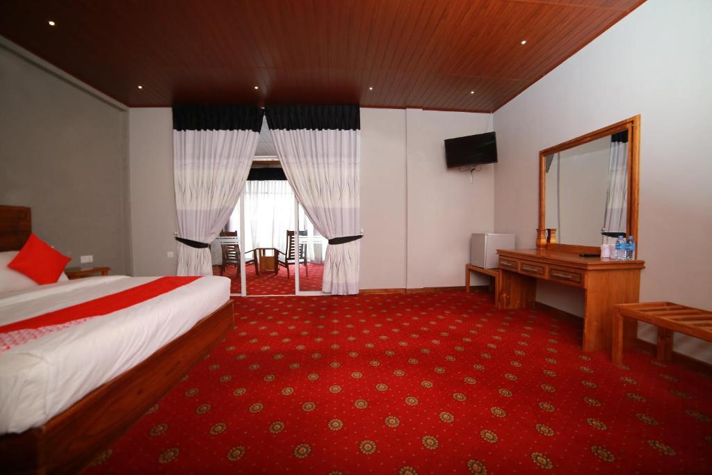 Postel nebo postele na pokoji v ubytování OYO 278 Hotel Rivelka