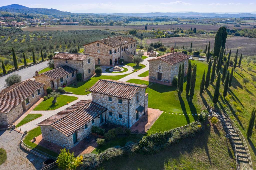 an aerial view of a mansion with cypress trees at Agriturismo San Lorenzo in Serre di Rapolano