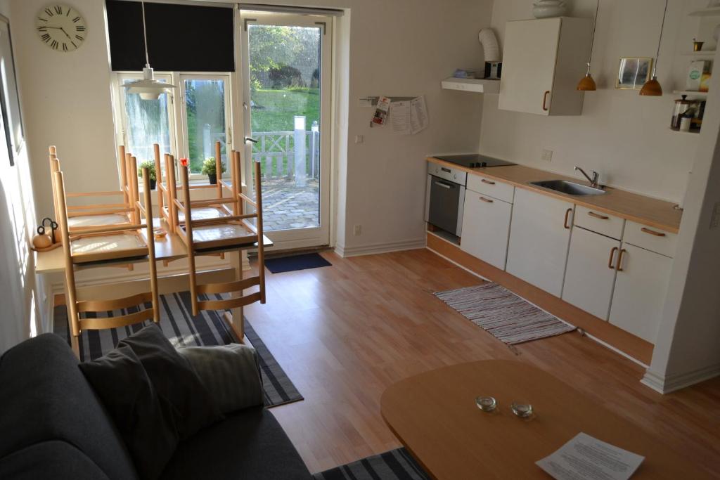 a kitchen and living room with a table and chairs at Vilstruplund in Otterup