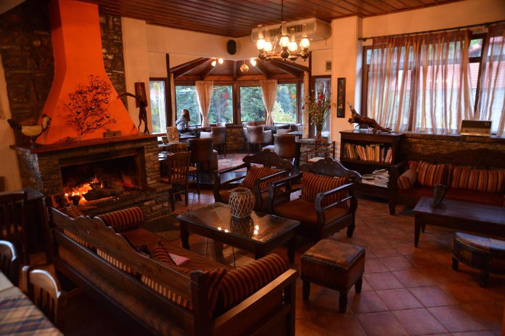 a lobby with couches and a fireplace in a restaurant at Ta Petrina in Ano Chora