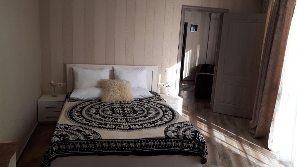 アドレルにあるАпартаменты на Бестужеваのベッドルーム1室(ベッド1台、白黒の掛け布団付)