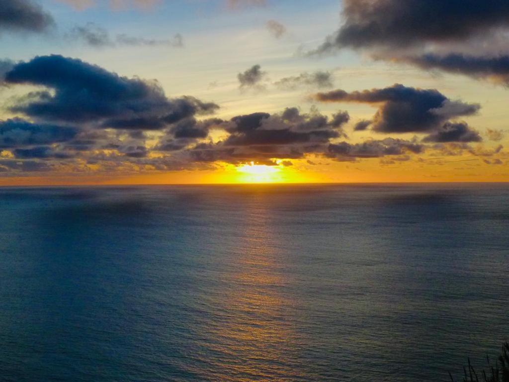 a sunset over the ocean with the sun setting at Atlantis Country House in Calheta