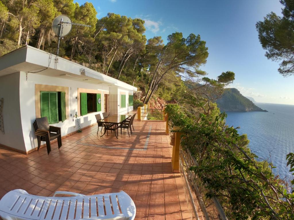 a house with a deck with a view of the water at Son Riera Petit Paradís in Banyalbufar