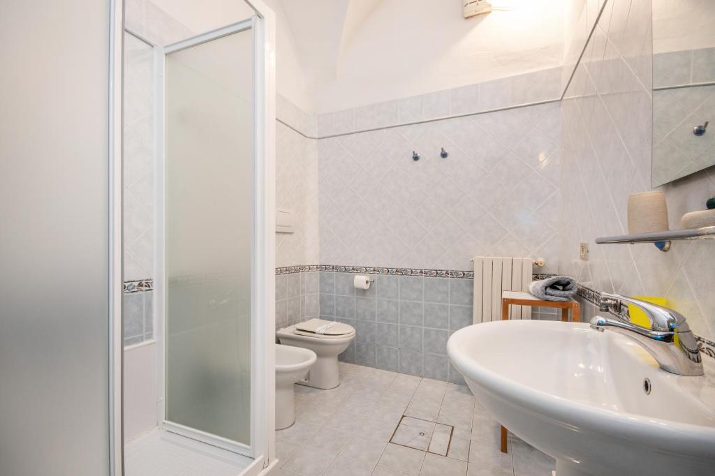 a bathroom with a sink and a toilet at Agriturismo La Filanda in Manerba del Garda