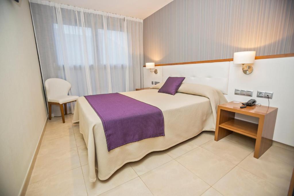 Cama o camas de una habitación en Hotel Teruel