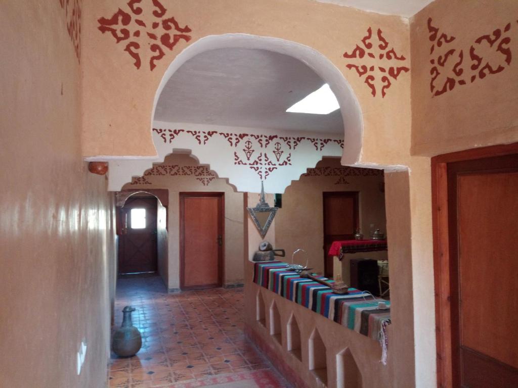 a hallway in a house with drawings on the walls at Dar Zara in Ouarzazate