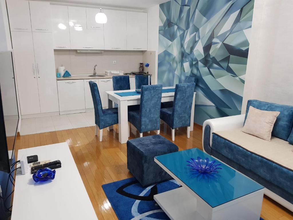 a living room with a table and a couch at Apartman KEJ BLUE free parking in Kraljevo