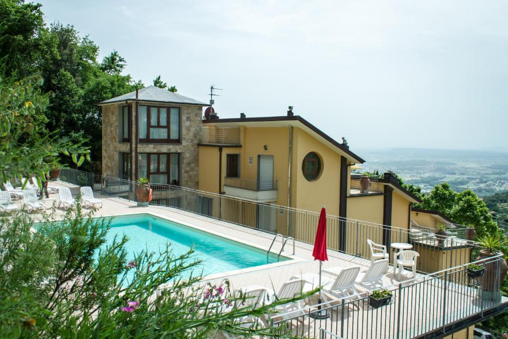 a villa with a swimming pool and a house at Residence Montefiore in San Baronto
