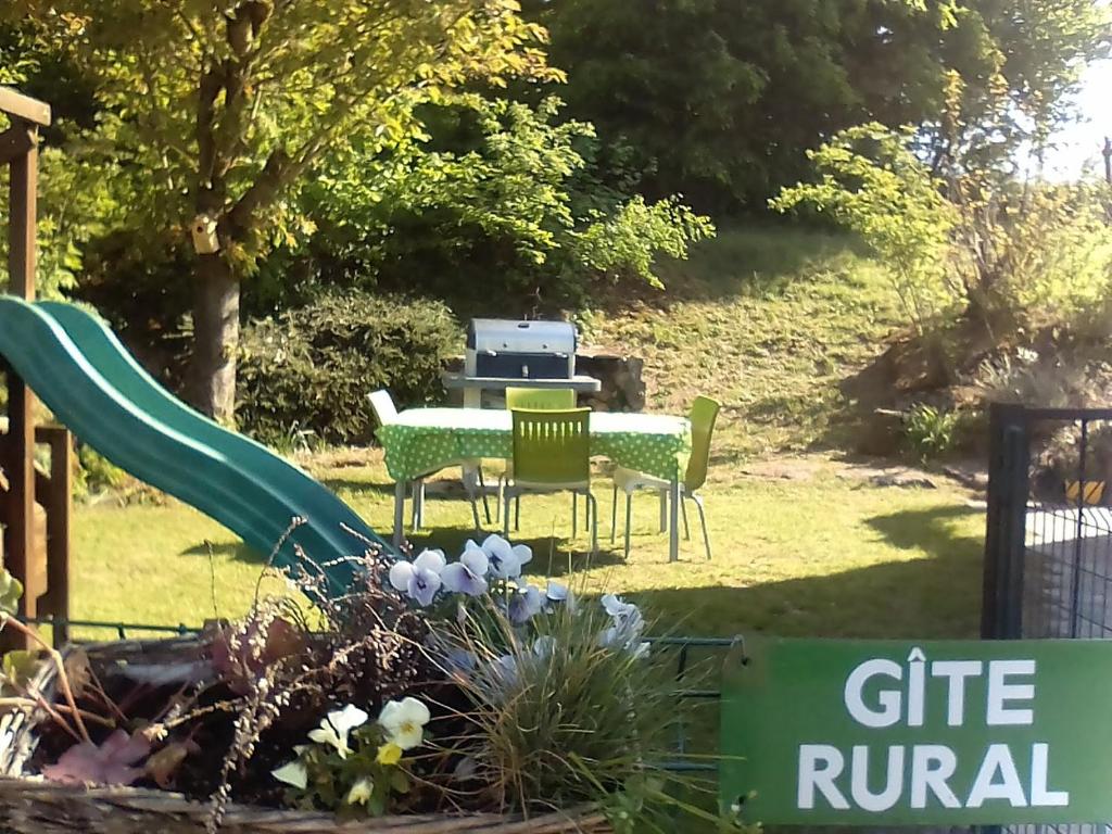 - un jardin avec une table, des chaises et un toboggan dans l'établissement Gite proche du Val Joly - 4911 -, à Willies