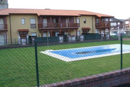 a fence in front of a house with a swimming pool at Casa Santa Ana in Ajo