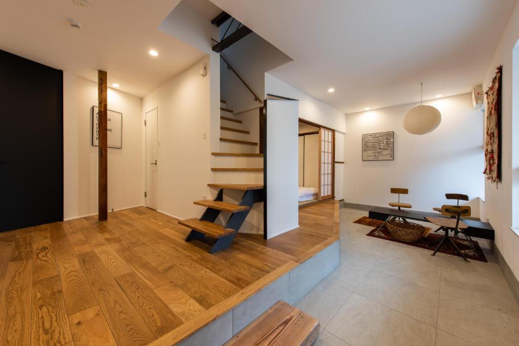 a house with a staircase in the middle of a room at Kamin Kanazawa in Kanazawa