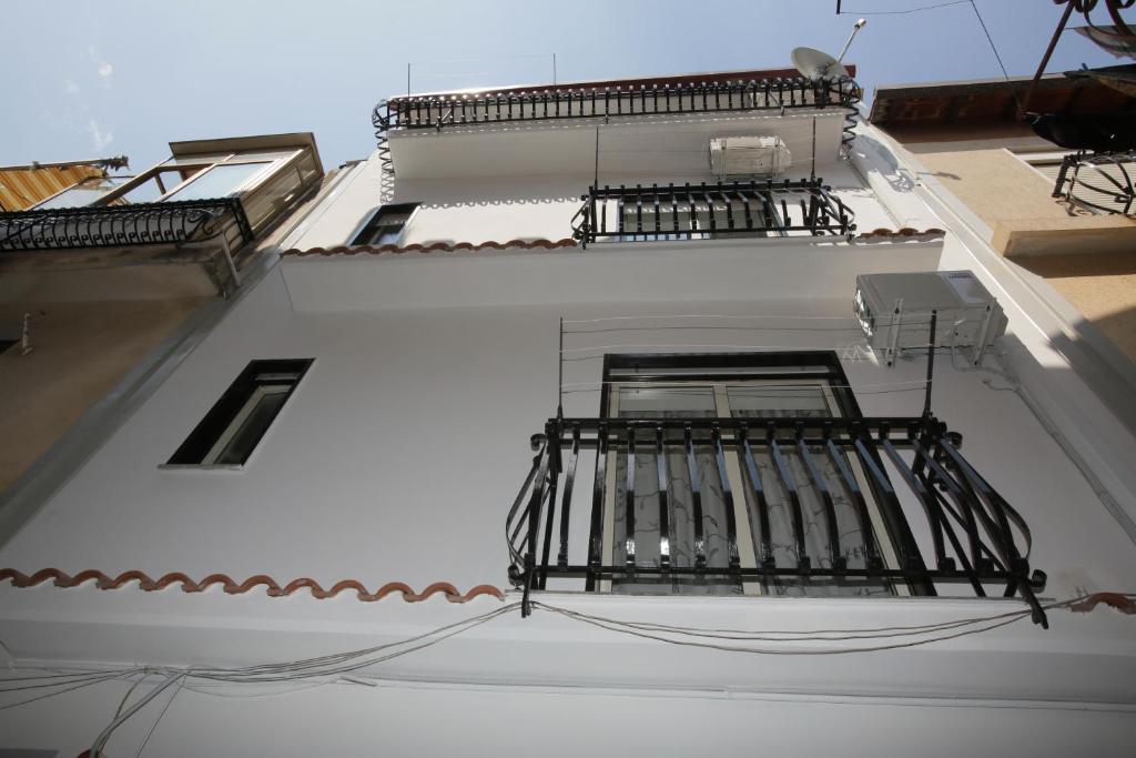a white building with a balcony with a letter z on it at Appartamento Topazio in Letojanni
