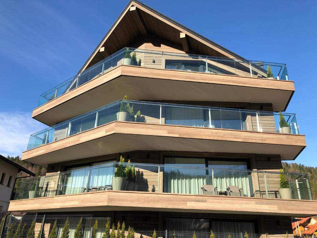 a tall building with balconies on top of it at SKI-Art Apartments in Szczyrk