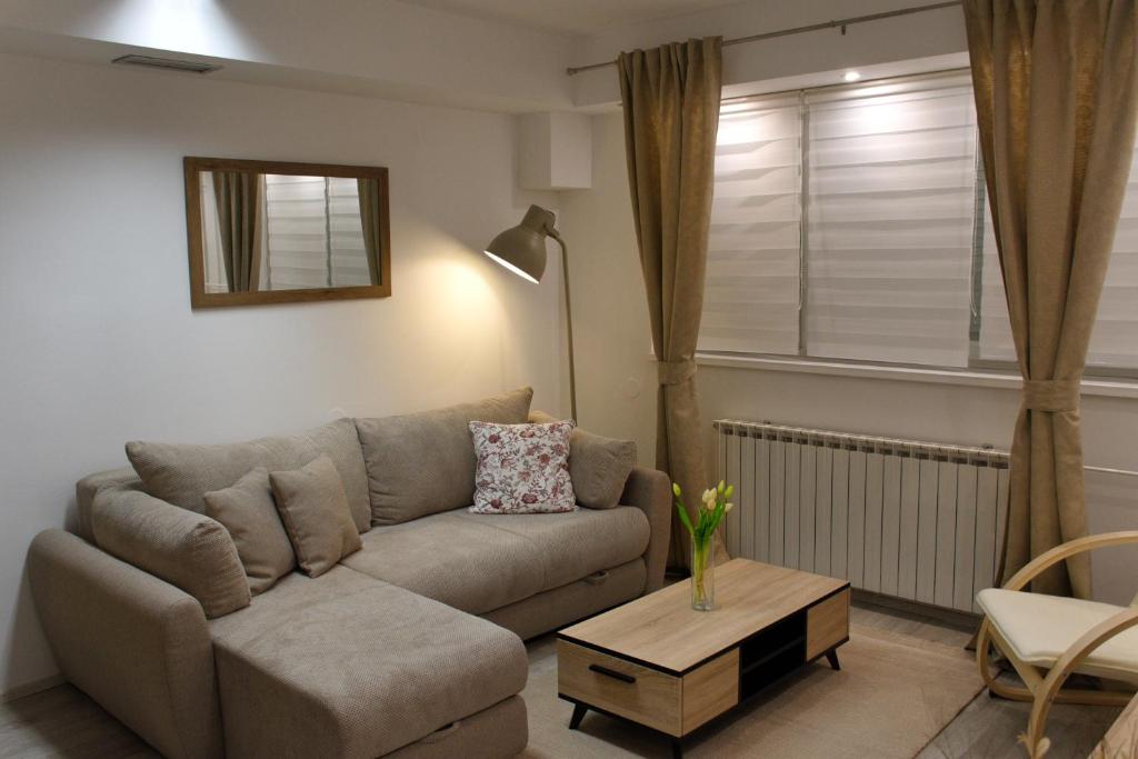 a living room with a couch and a table at Apartment Anna - FREE pickup from OR dropoff to Zagreb airport, please give three days advance notice - EV station - Long-term parking with airport transport possibility in Velika Gorica