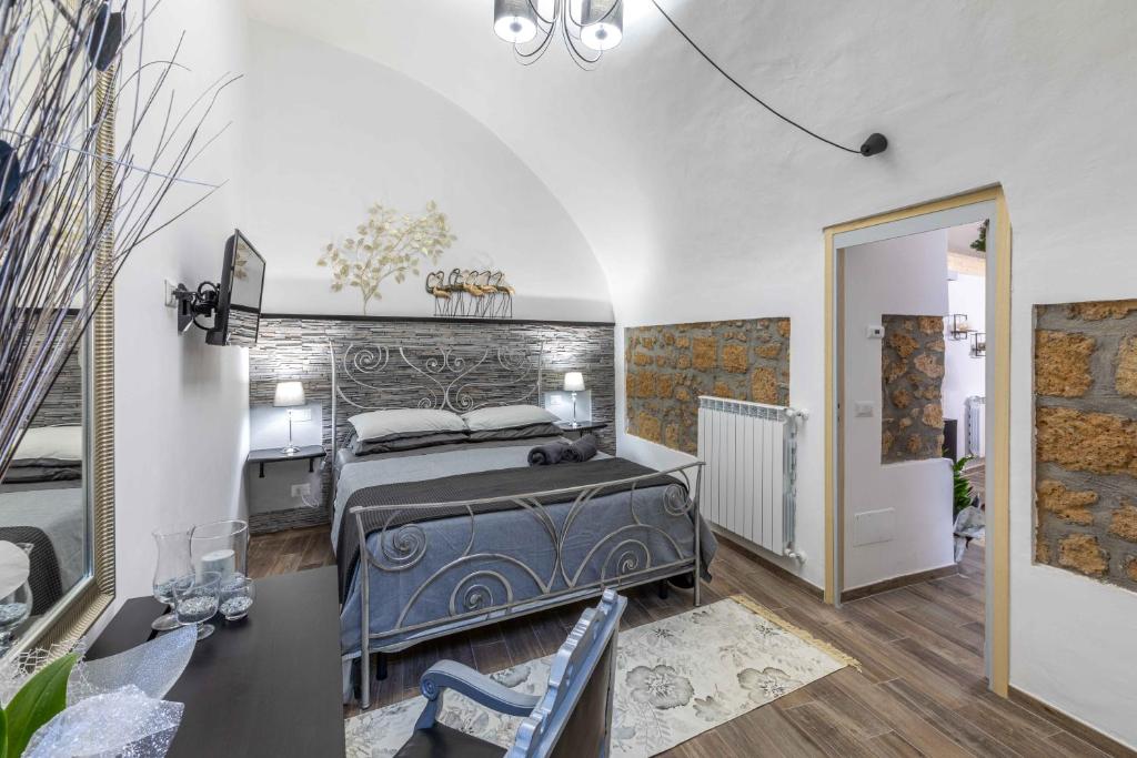 a bedroom with a bed with a stone wall at Casa Patrizia in Orvieto