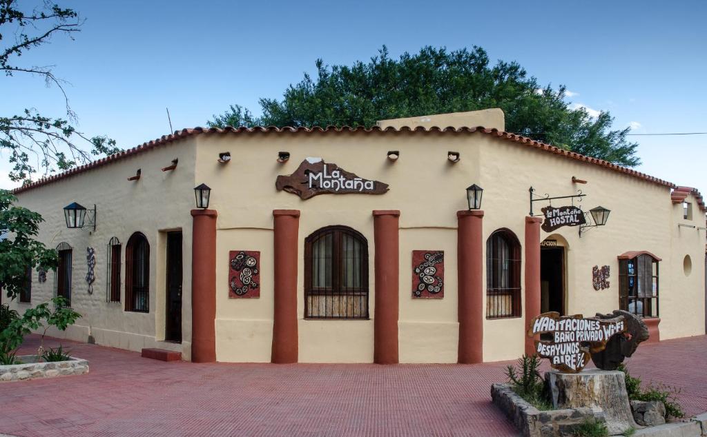 a building with a sign on the side of it at La Montaña in Cafayate