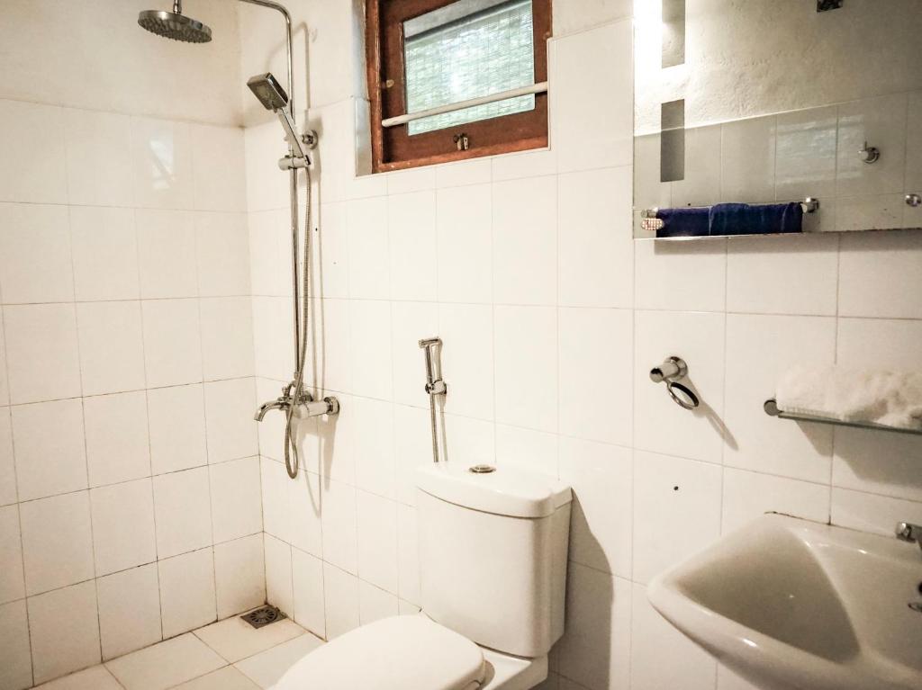 a bathroom with a toilet and a sink at Nuga Eden Tangalle in Tangalle