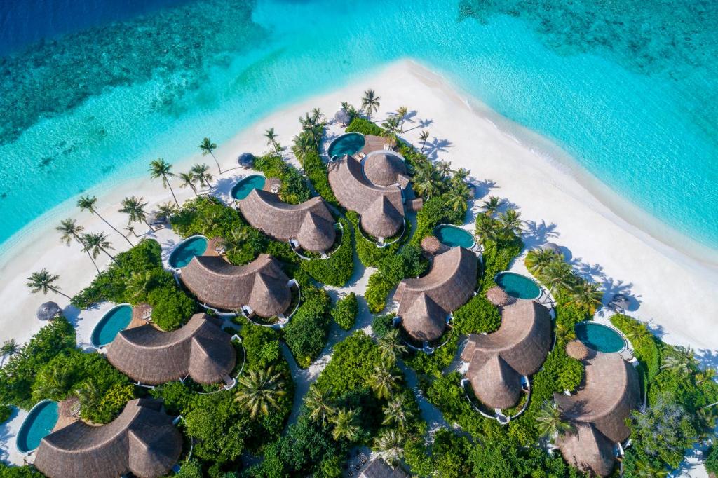 an aerial view of a resort on a beach at Milaidhoo Maldives in Baa Atoll