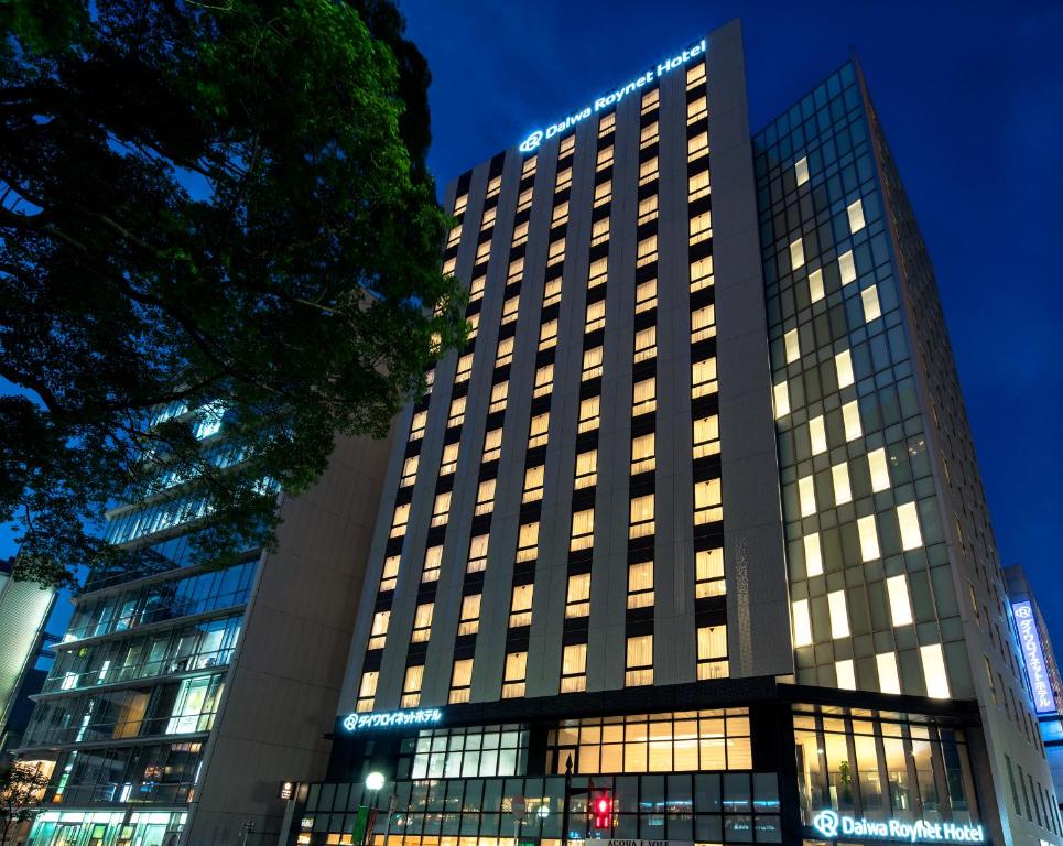 a tall building with lights on it at night at Daiwa Roynet Hotel Chiba-chuo in Chiba