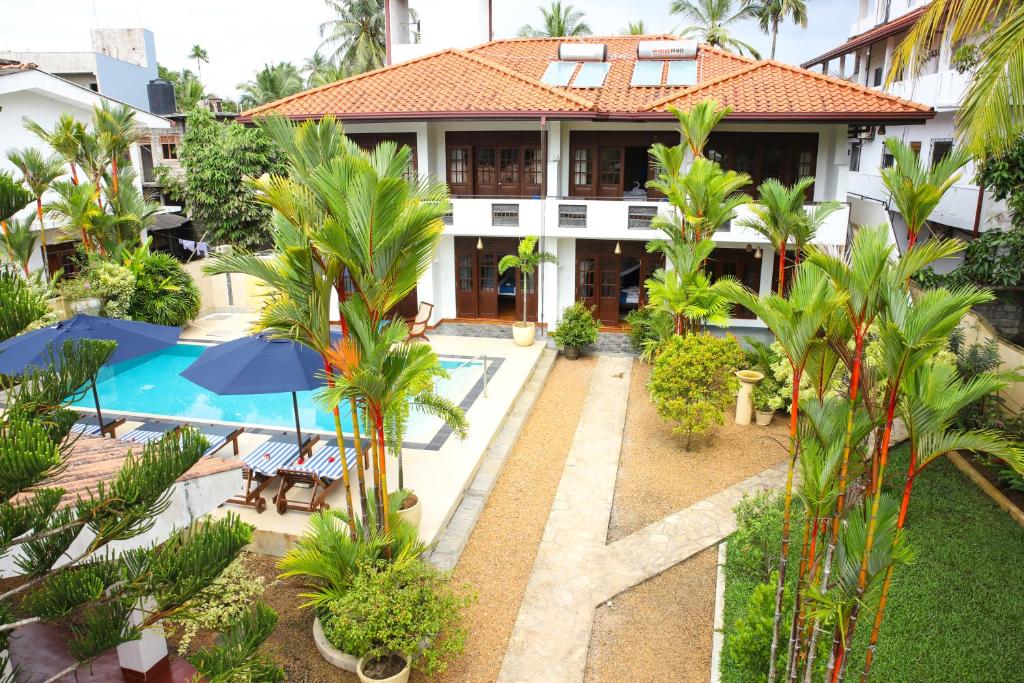 an aerial view of a house with a pool and palm trees at Sky and Sand Guesthouse in Beruwala