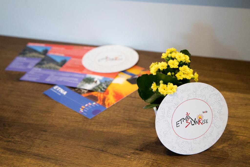 a vase filled with flowers sitting on a wooden table at Etna Sunrise b&b in Zafferana Etnea