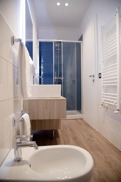 a white bathroom with a sink and a mirror at Etna Sunrise b&b in Zafferana Etnea