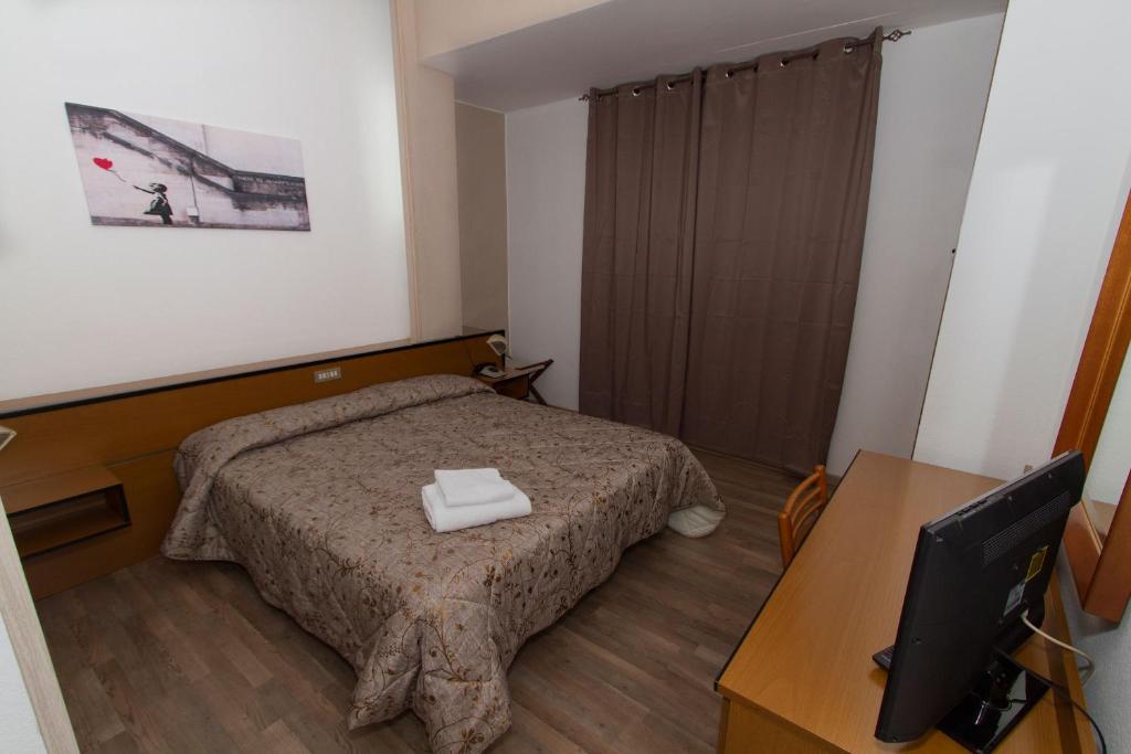Postel nebo postele na pokoji v ubytování Albergo Martini