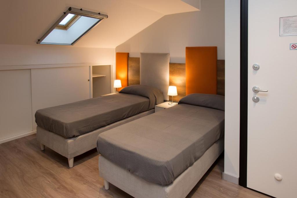 a bedroom with two beds and a skylight at Etna Sunrise b&b in Zafferana Etnea