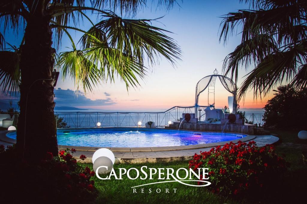 a resort swimming pool with a roller coaster at CapoSperone Resort in Palmi