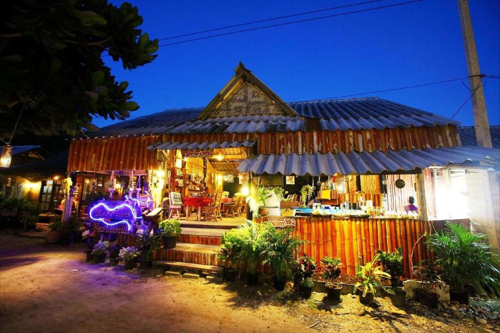 a food stand at night with lights at PP Red Tuna Hut in Phi Phi Don
