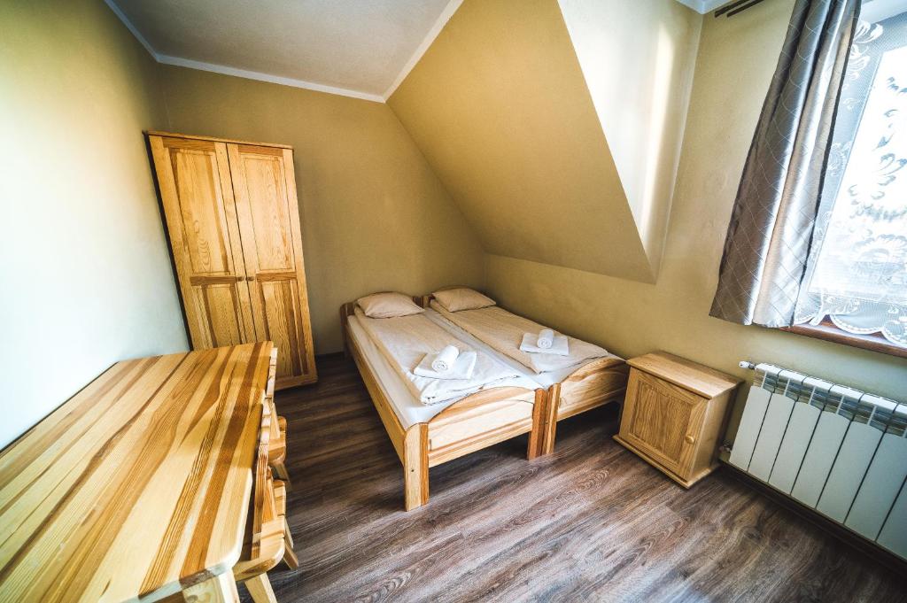 Posteľ alebo postele v izbe v ubytovaní Pokoje i Apartamenty Nad Potokiem