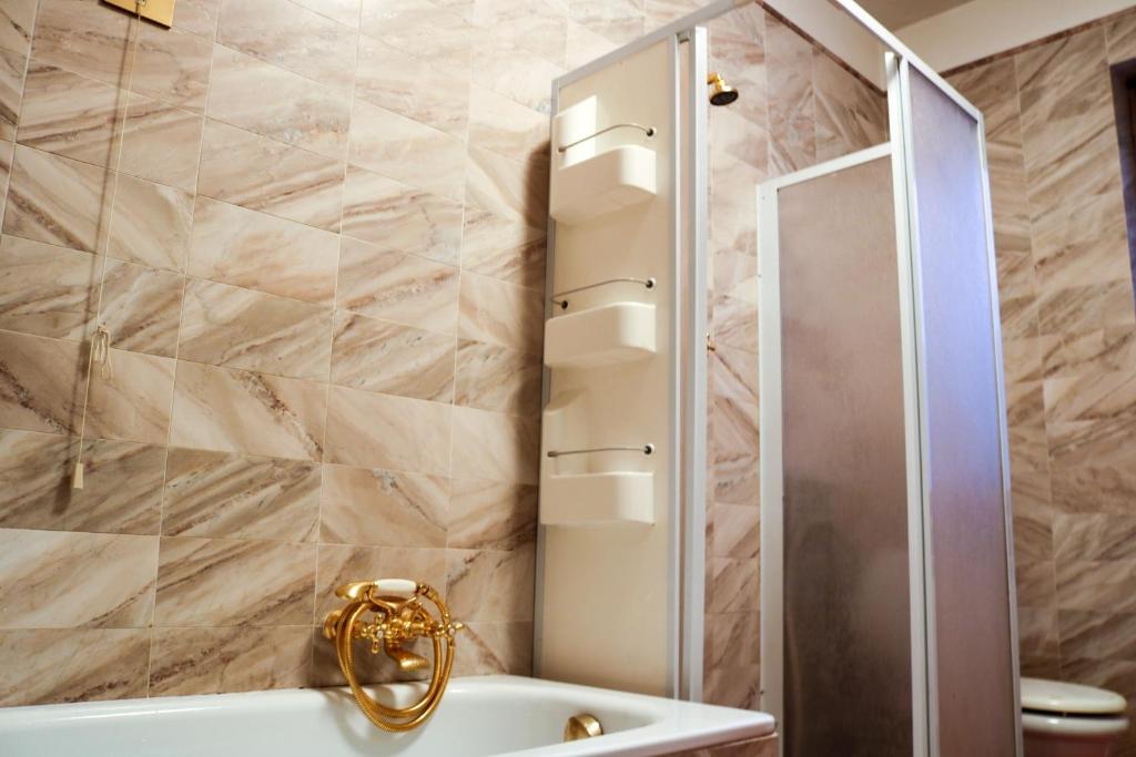 a bathroom with a shower and a tub and a sink at Villa La Perla in Corsanico-Bargecchia