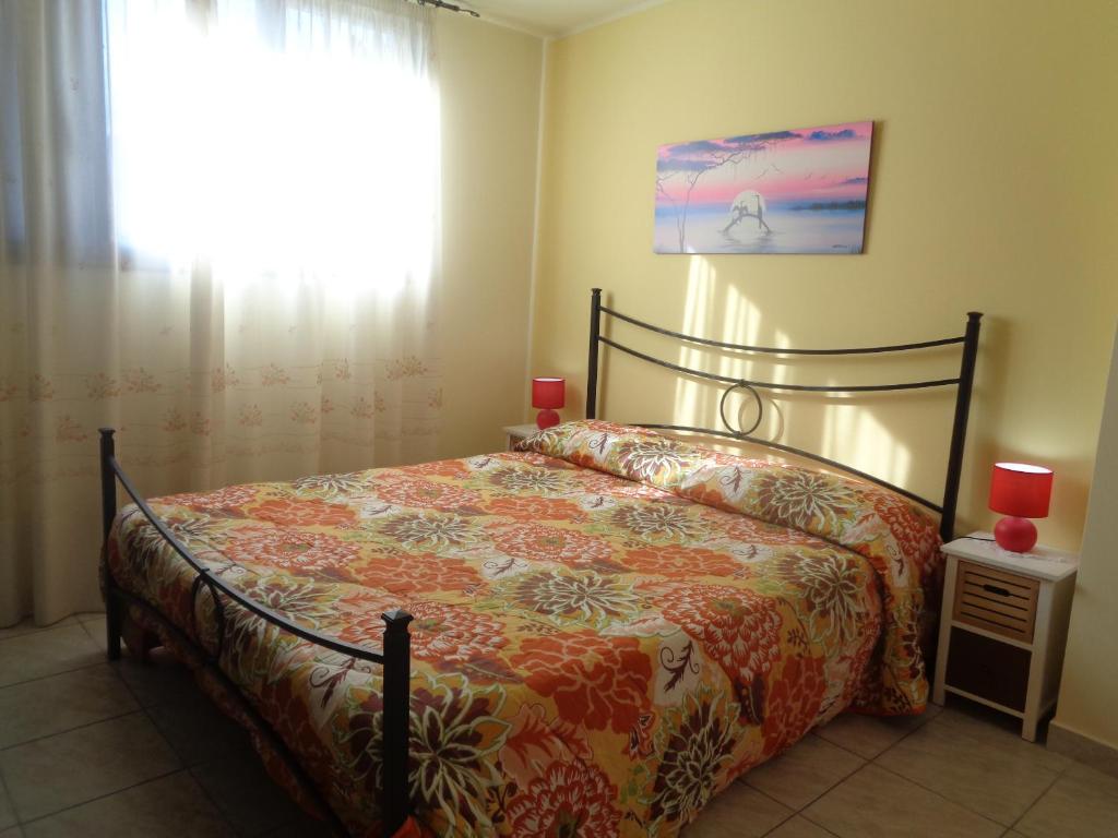 a bedroom with a bed and a window at Antico Borgo in Castiglione di Sicilia