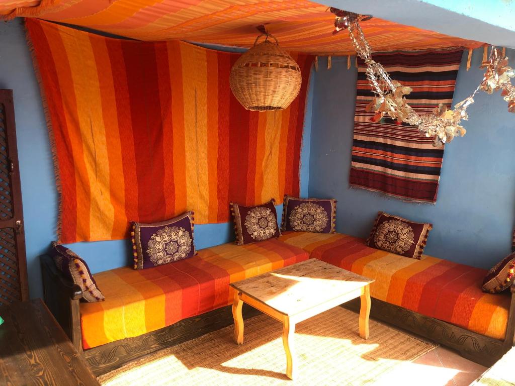 a living room with a couch and a table at Surf and Skate hostel taghazout in Taghazout