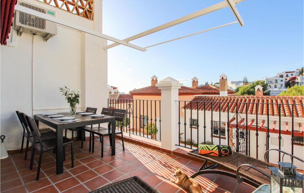 a patio with a table and chairs on a balcony at 3 Bedroom Stunning Apartment In Nerja in Nerja