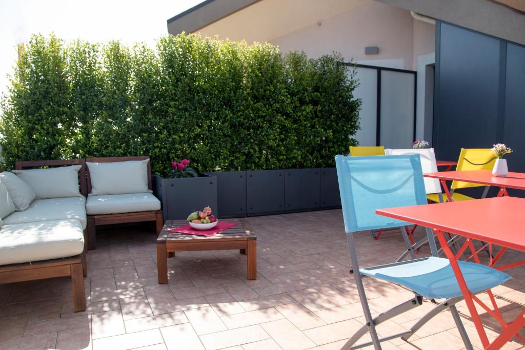 a patio with a couch and chairs and a table at Etna Sunrise b&b in Zafferana Etnea