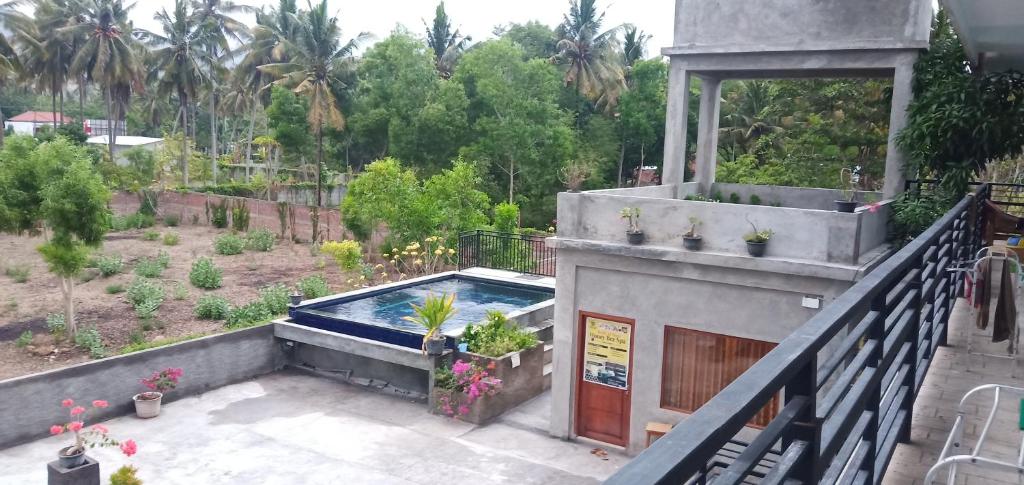 a house with a swimming pool in a garden at Honeybee Homestay in Kuta Lombok
