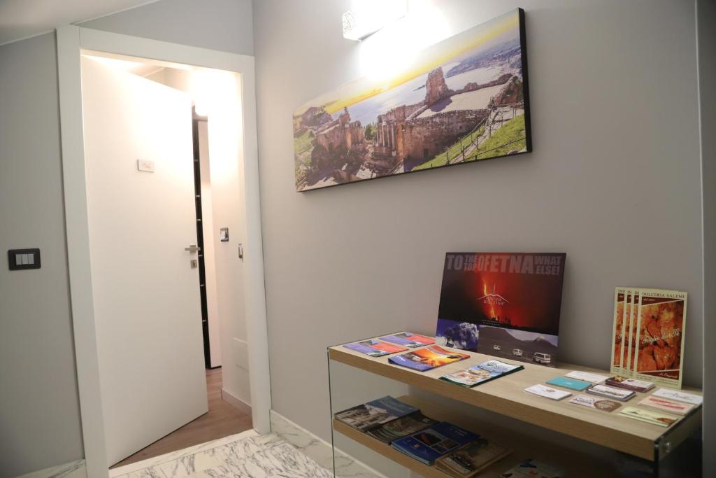a room with a desk and a painting on the wall at Etna Sunrise b&b in Zafferana Etnea