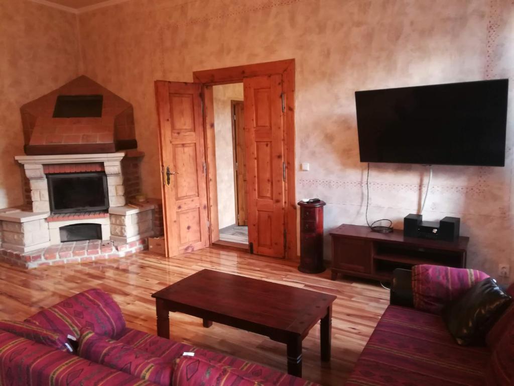 a living room with a couch and a tv at Isabellino údolí in Stříbro