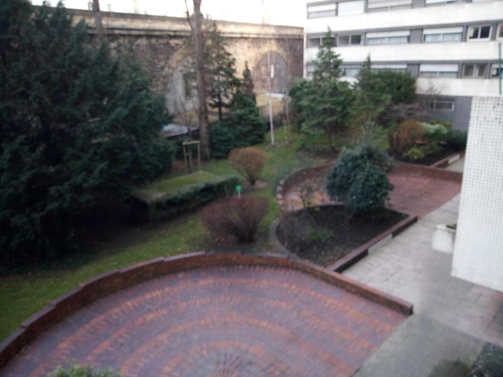 a view of a garden from a building at Homestay Rooms Paris Porte de Versailles in Paris