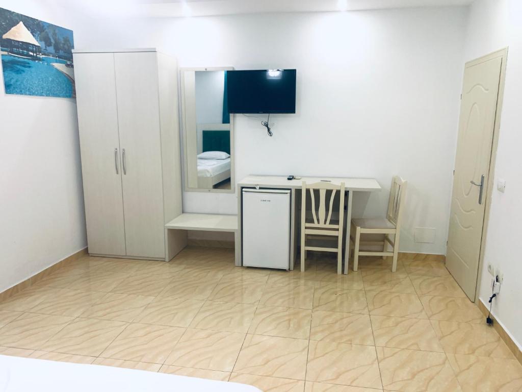 uma pequena cozinha com uma mesa e uma sala de jantar em Hotel Lakaj em Velipoja