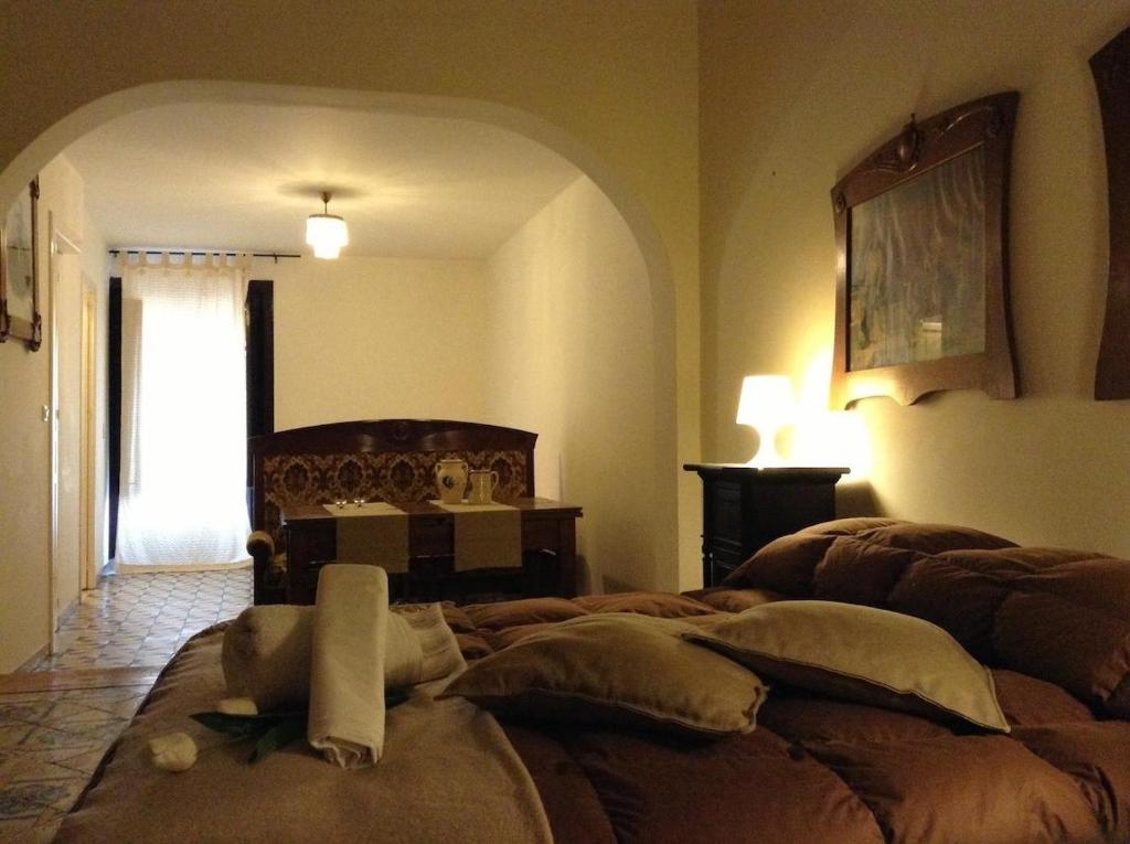a bedroom with a bed in a room with a window at Verdi Apartment in Castellammare del Golfo
