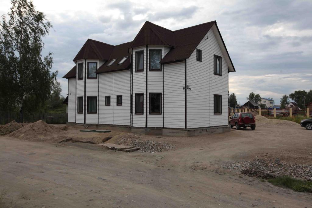 a house is being built in a parking lot at Guest House on Vokzalnaya in Nyandoma