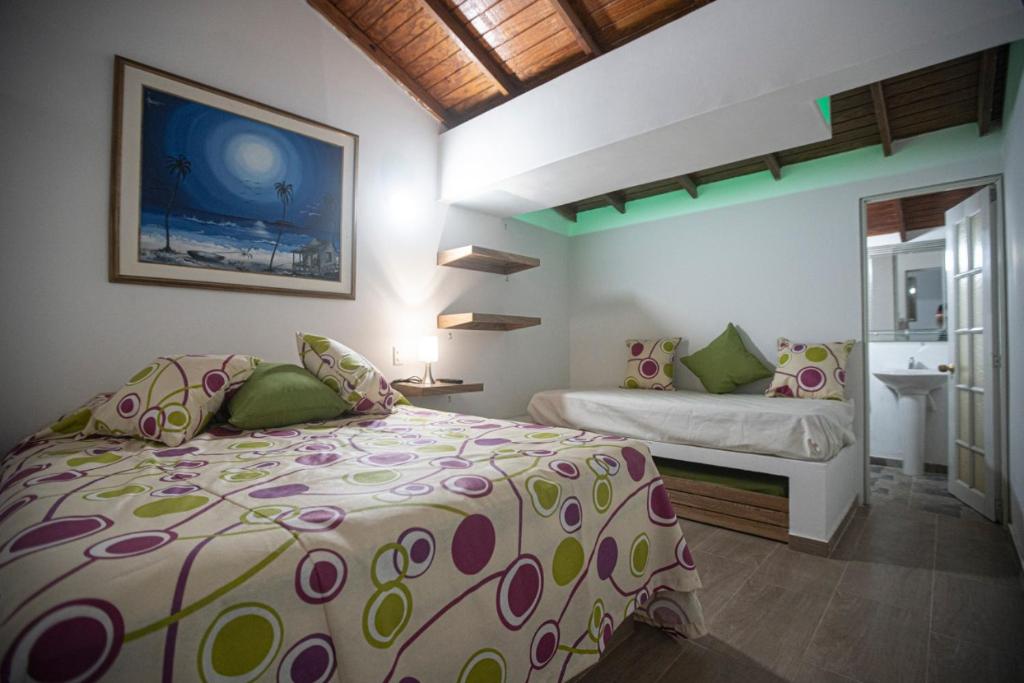 a bedroom with a bed and a sink in it at West House Lusitania in San Andrés