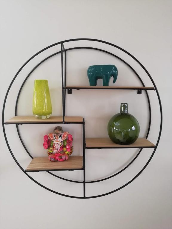a circular shelf with vases and an elephant on it at Private Lodge on Houseboat Amsterdam in Amsterdam