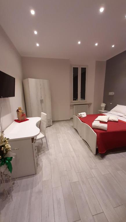 a bedroom with a bed and a desk and a sink at La Casa di Bea in Magliano deʼ Marsi