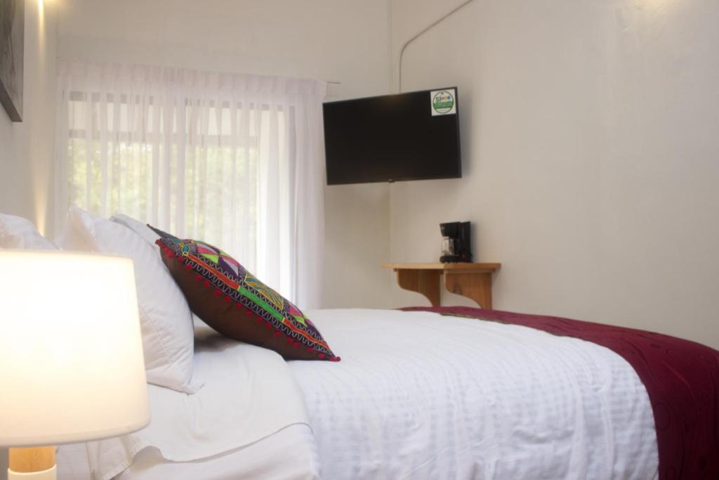 Postel nebo postele na pokoji v ubytování Cotinga Hotel Spa
