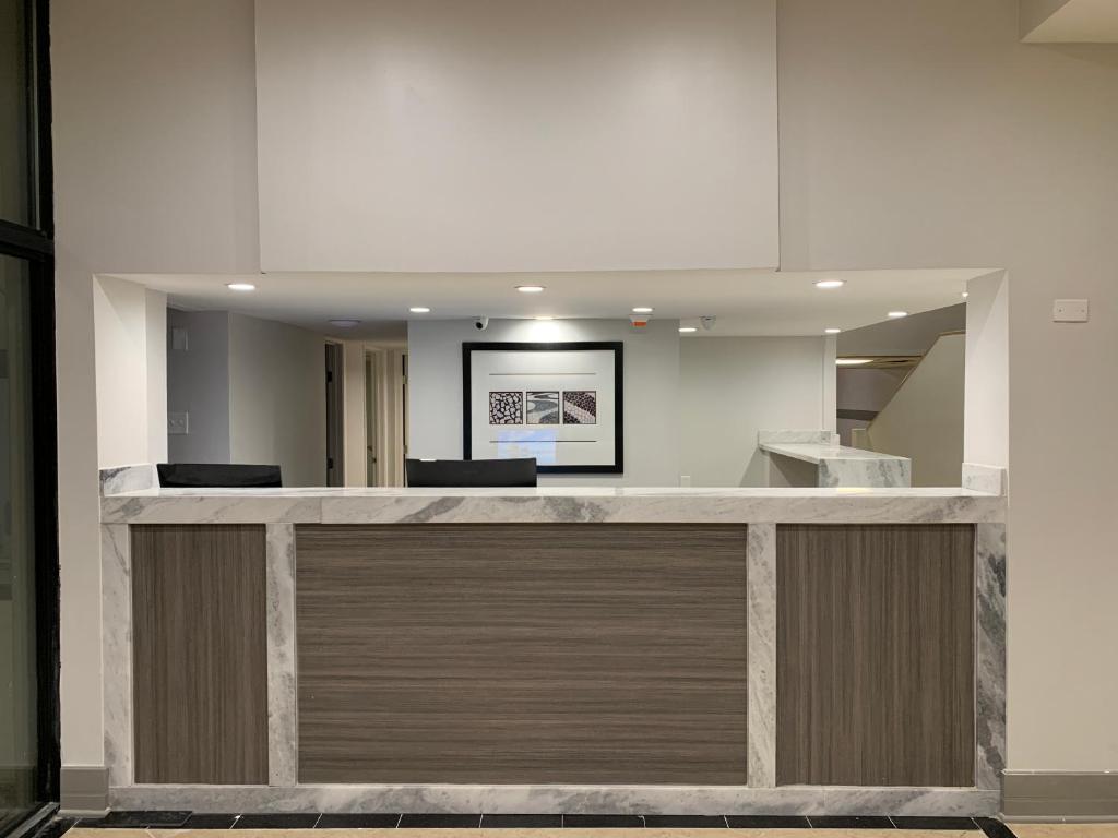 an office lobby with a reception counter with wood at The Hotel Orange in Orange