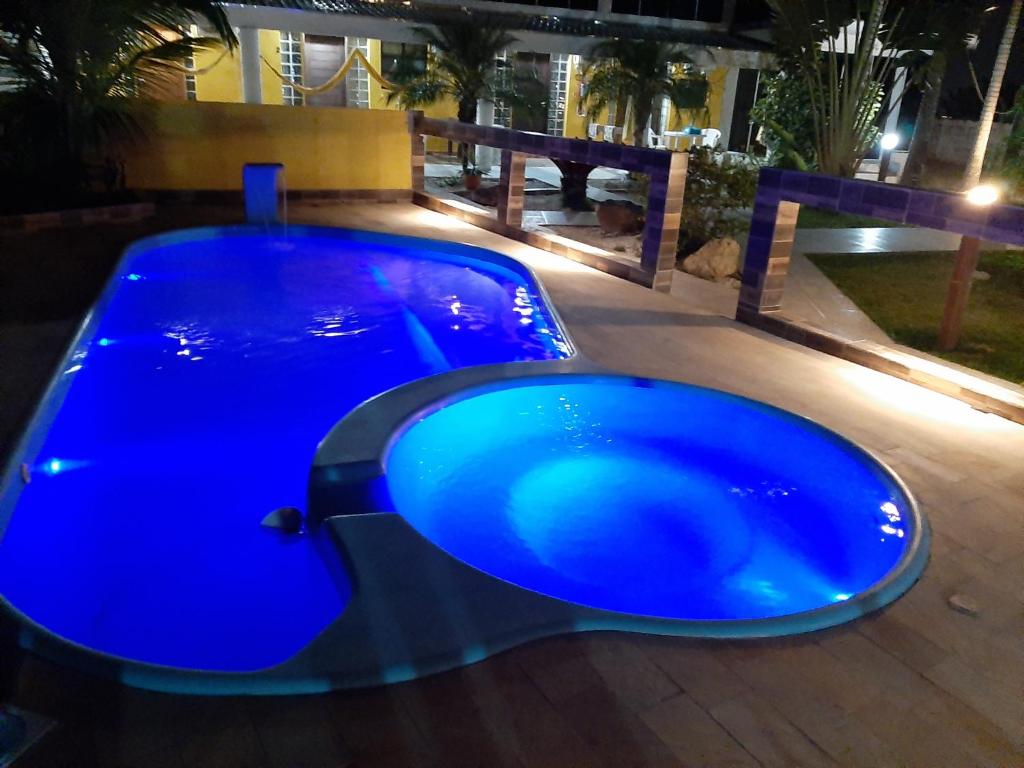a large blue swimming pool on a patio at Pousada Sossego in Penha